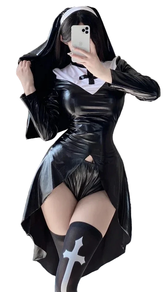 Model wearing a shiny black PVC gothic nun costume. The outfit includes a high-low mini dress with a white and black cross collar, black high-cut shorts, and sheer stockings with a white cross print, holding a small devil pitchfork prop.