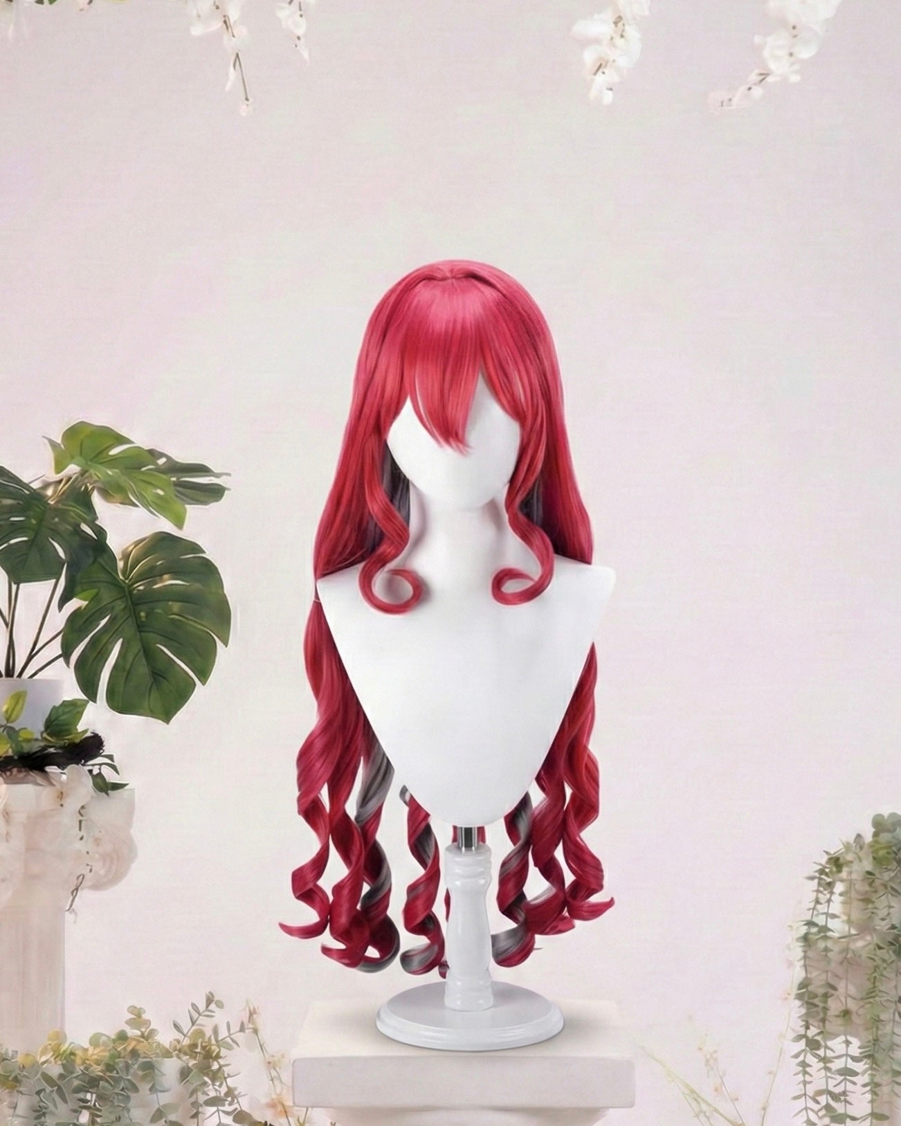 Red wig on a mannequin head with a white background