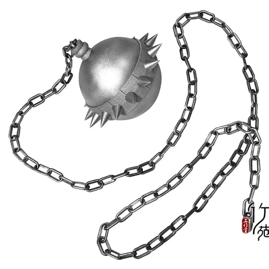 Close-up shot of a metallic silver, spiked ball (flail) attached to a long silver chain, designed as the weapon prop for the character Gogo Yubari from Kill Bill.