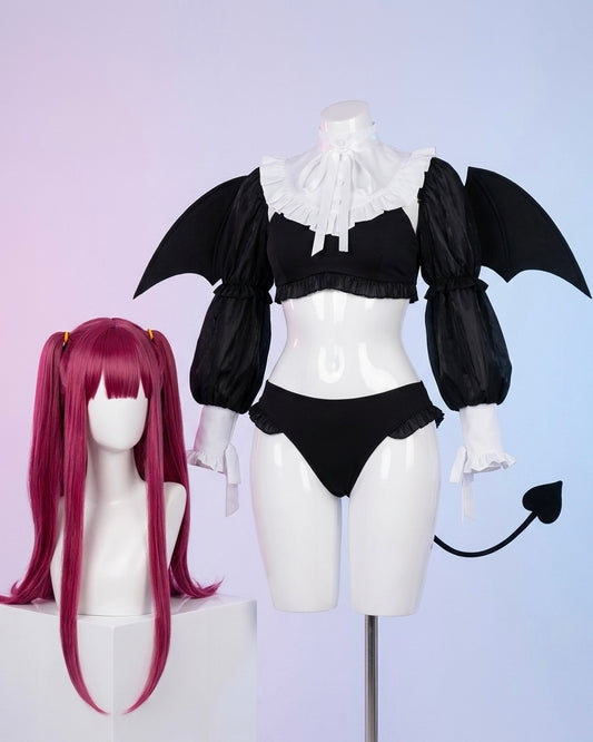 Black and white outfit with bat wings on a mannequin, pink wig on a separate stand.