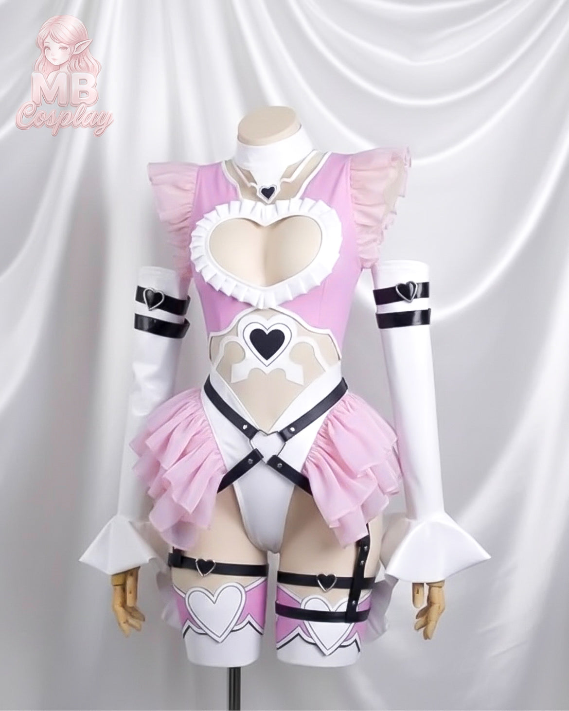 A front view of the Doll 2B cosplay costume on a mannequin. The outfit features a pink and white bodysuit with a heart-shaped chest cutout, ruffled shoulders, black harness detailing, and matching arm sleeves.