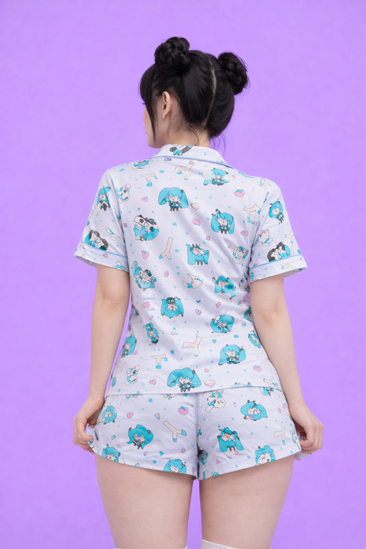 Person wearing a pajama set with cartoon designs on a purple background