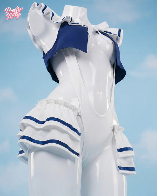 Side angle of the white and navy sailor bodysuit showing the high-cut silhouette and tiered ruffle details.