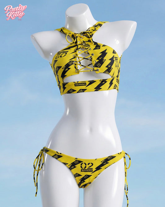 Front view of the yellow and black Zero Two Hazard set featuring a lace-up top and warning graphics.