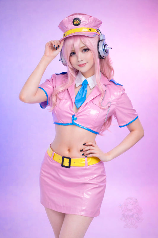 Model posing in the glossy pink Super Sonico Space Police crop top, mini skirt, yellow belt, and police hat, wearing the pink wig and silver headset